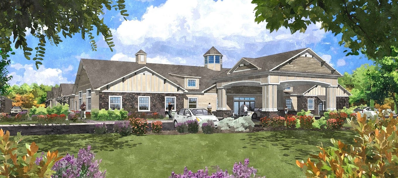 Exterior view of a senior living facility surrounded by gardens