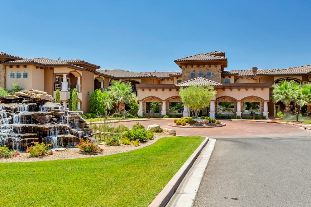 Exterior view of The Retreat at Sunbrook with landscaping and water feature