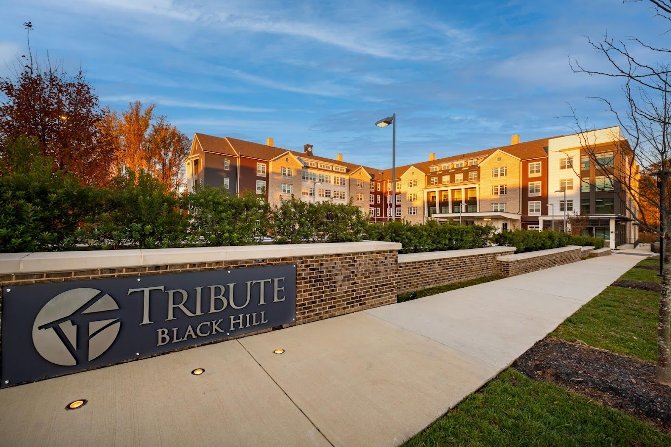 Exterior view of Tribute at Black Hill facility with logo