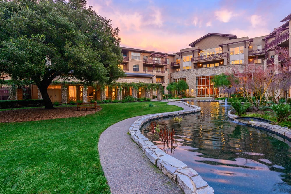 Beautiful landscaped outdoor area with pond and building
