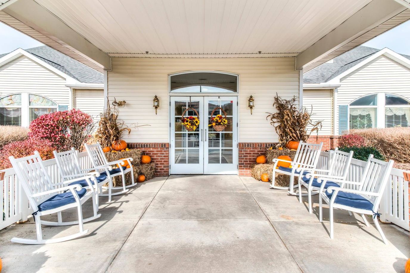 Entrance of an assisted living facility decorated for fall