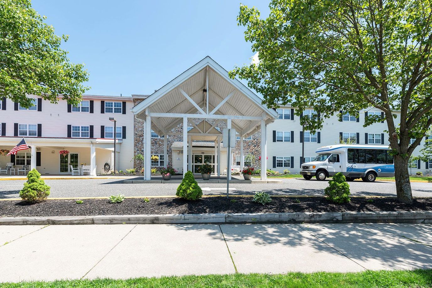Building entrance with transport vehicle and landscaped area