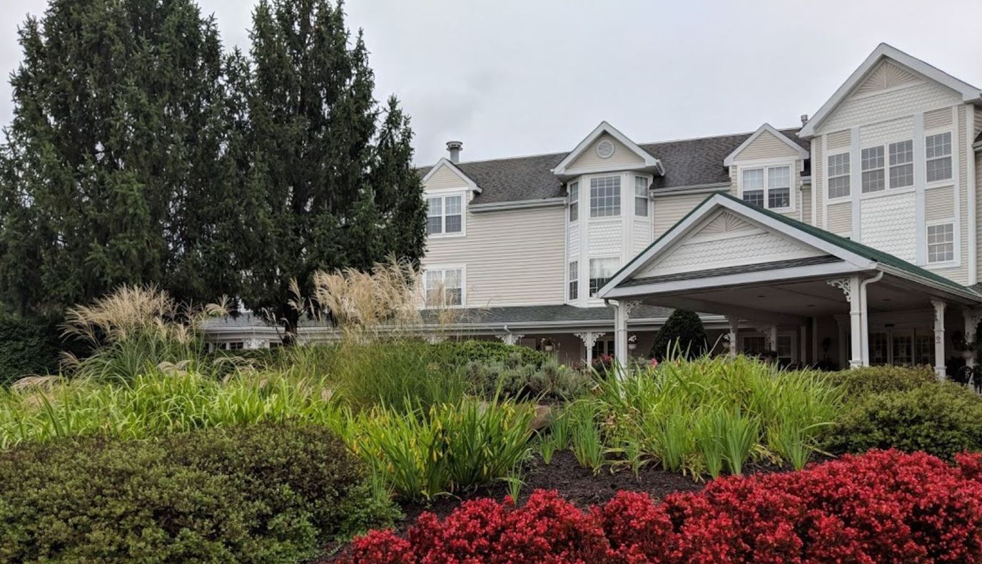Exterior view of a senior living facility with landscaped gardens