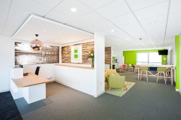 Bright, modern common area with seating and reception desk