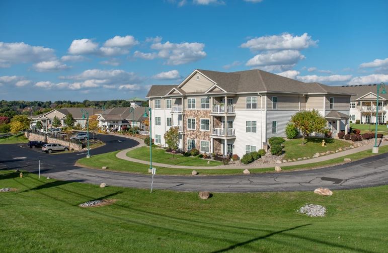 Aerial view of a senior living facility with landscaped grounds