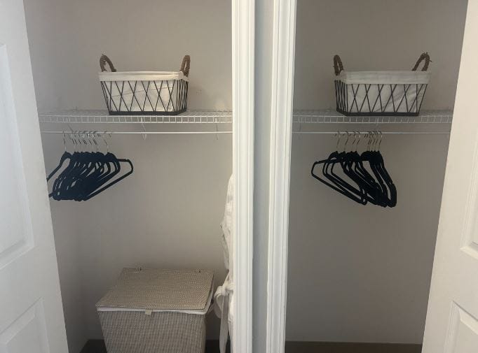 Wardrobe closet with hangers and storage baskets