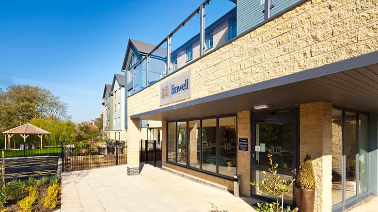 Exterior view of The Amwell Care Home showing the entrance and garden areas.