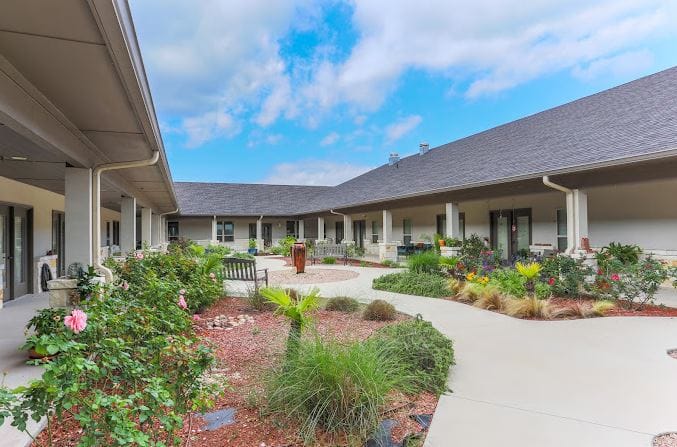 Beautiful landscaped courtyard with walking paths and benches