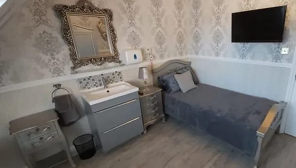 Ashbourne House Care Home, care home in Bristol, UK — Stylishly appointed bedroom with light colors and modern furniture