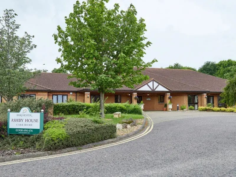 Exterior view of Ashby House Care Home with landscaping