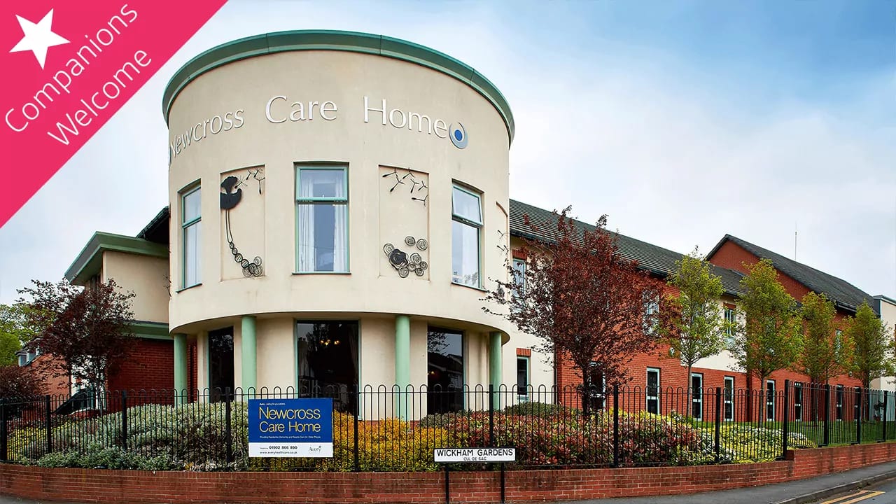 Exterior view of Newcross Care Home with a welcoming garden