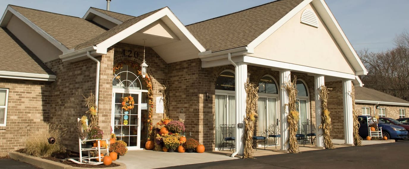 Exterior view of a senior living facility decorated for fall