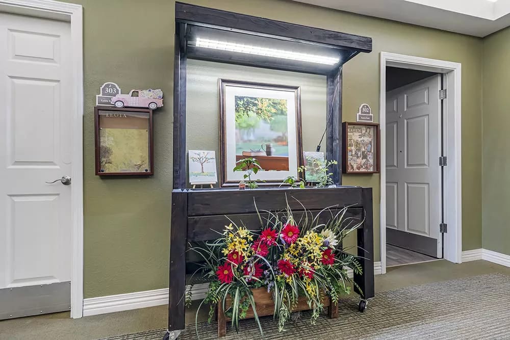 Entryway decorated with flowers and art at Brookdale Sleepy Hollow