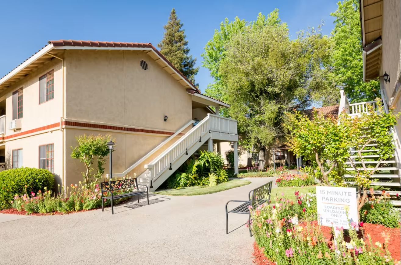 Exterior view of the assisted living facility with gardens