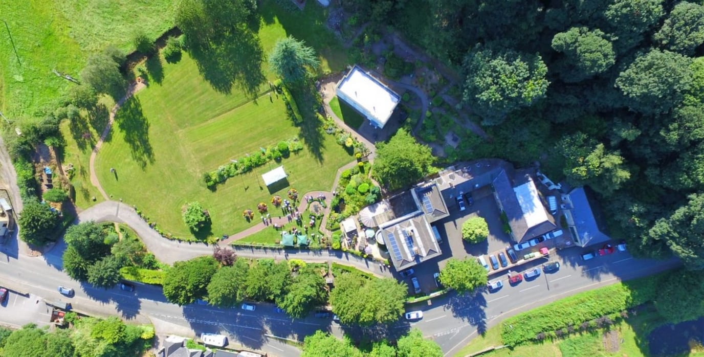 Aerial view of the facility surrounded by green spaces