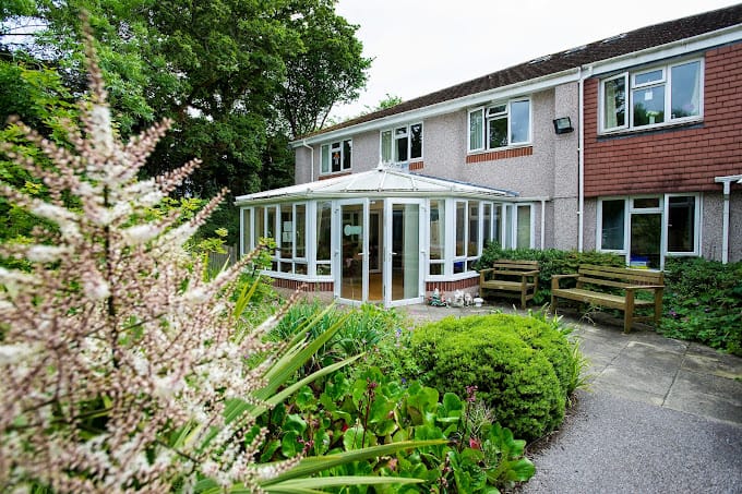 Exterior view of a residential nursing home with gardens