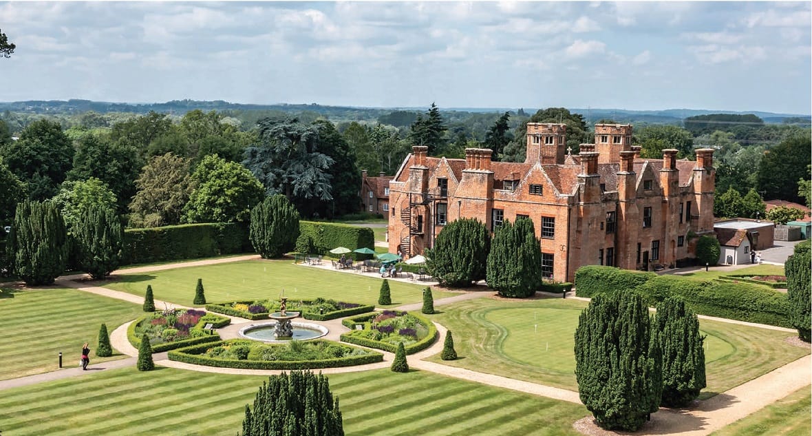 Aerial view of a large retirement facility and gardens