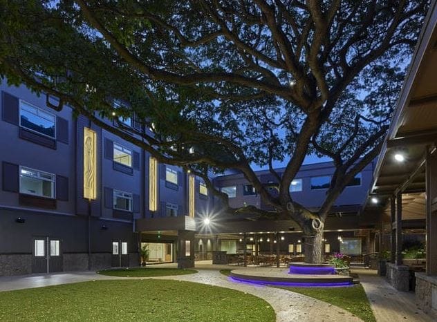 Outdoor courtyard with seating and tree