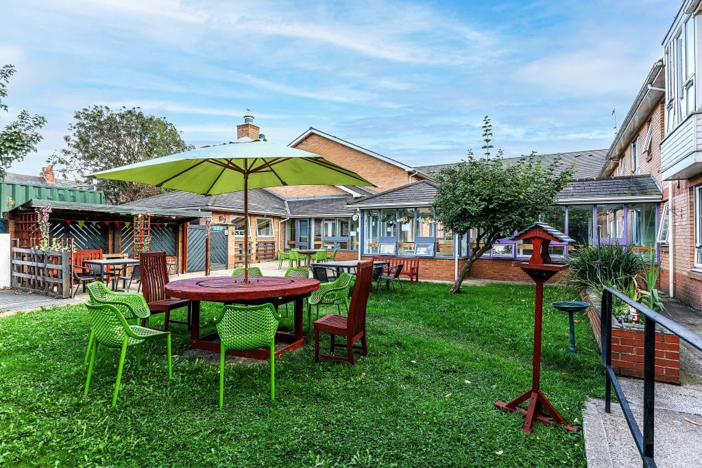 Outdoor seating area in a garden with picnic tables