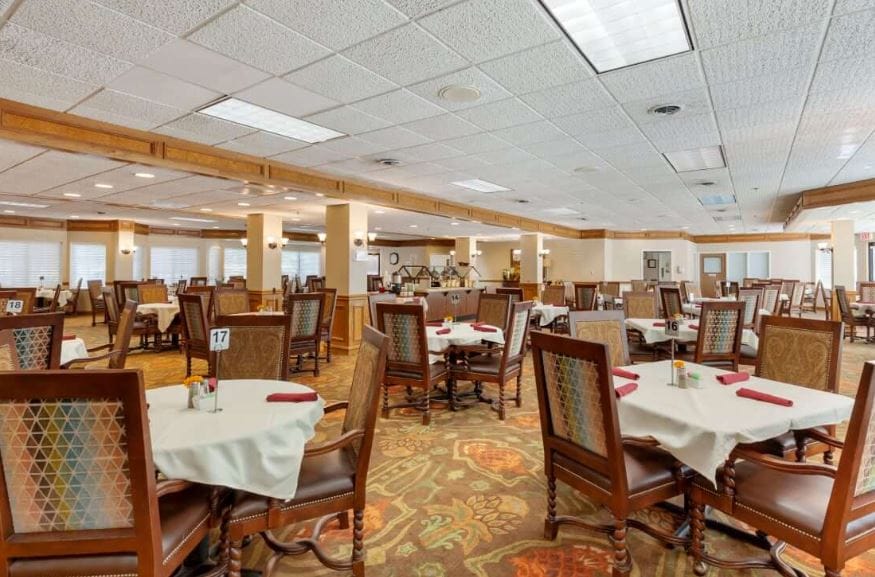 Interior view of the dining room with tables set for meals.