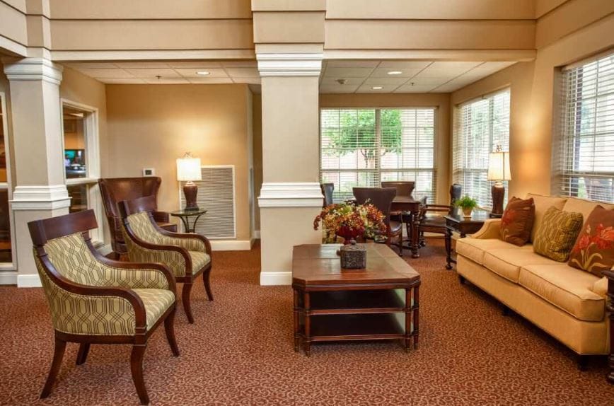 Lounge with chairs, coffee table, and large windows