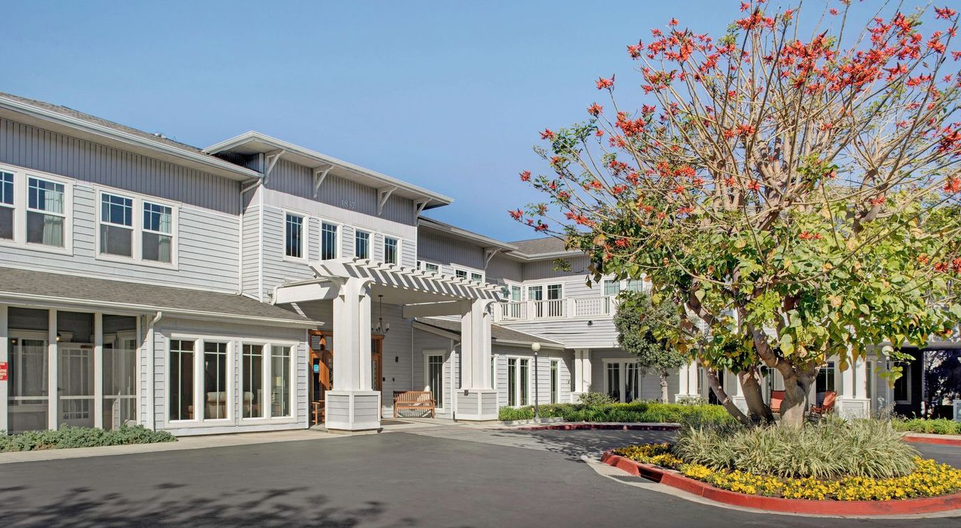 Exterior view of the assisted living facility with blooming trees