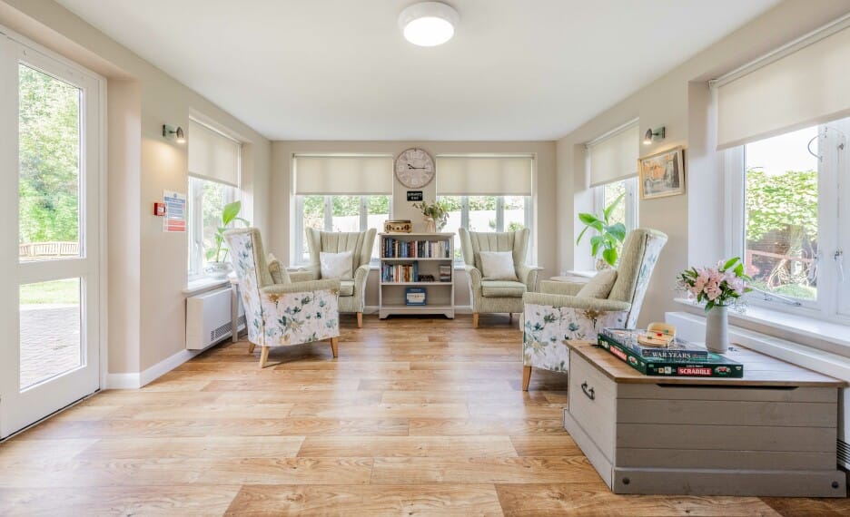 Bright common area with comfortable seating and bookshelves