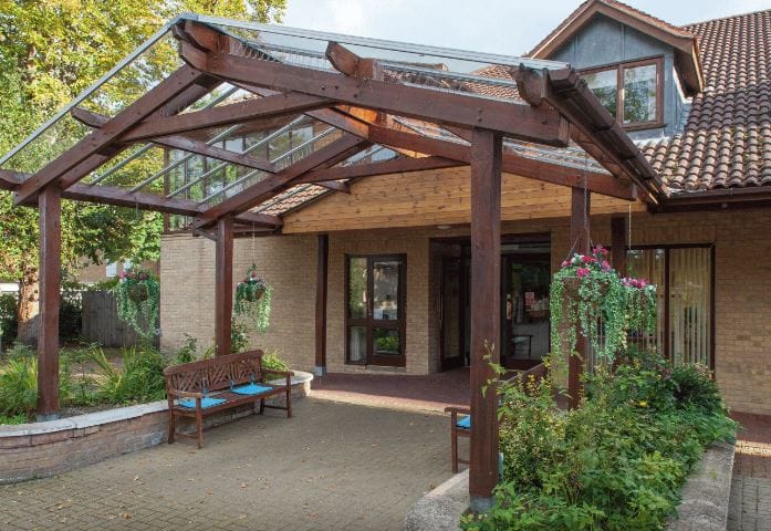 Entrance of Kingfisher House Care Home with outdoor seating