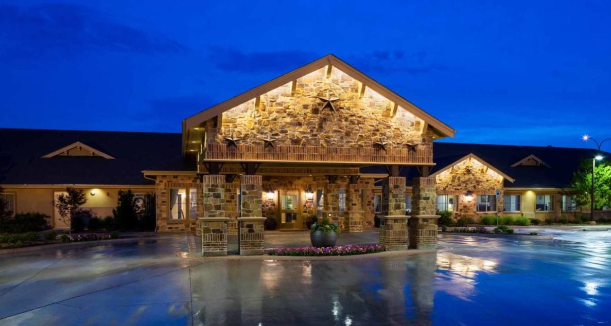 Exterior view of Meadowbrook Memory Care Community at night