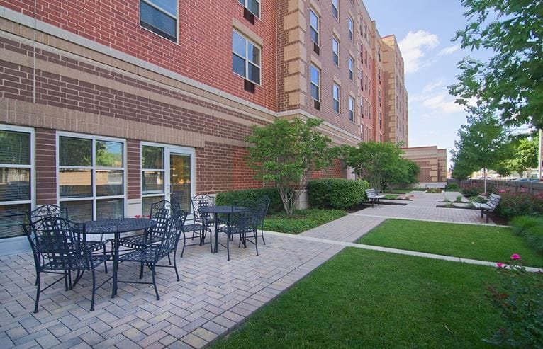 Outdoor patio area with seating and greenery