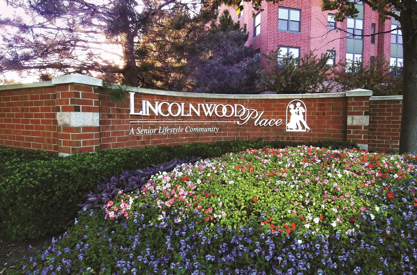 Exterior view of Lincolnwood Place facility sign with flowers