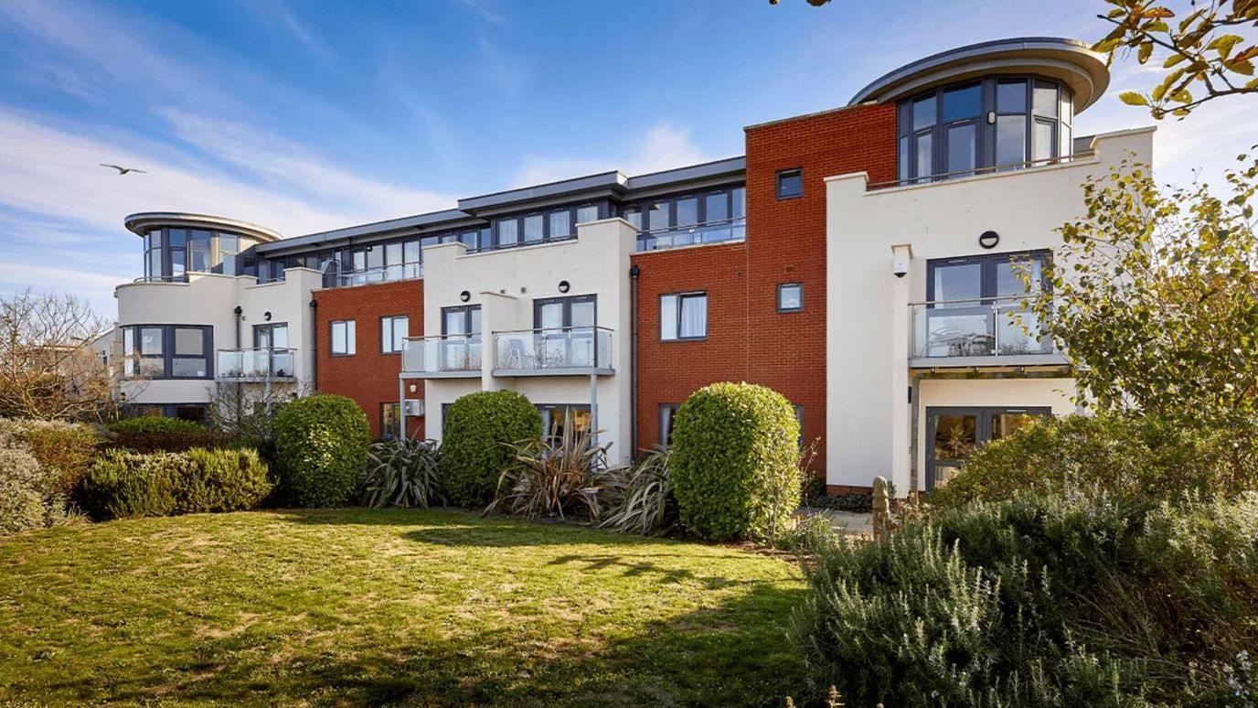 Exterior view of Miramar Care Home with gardens