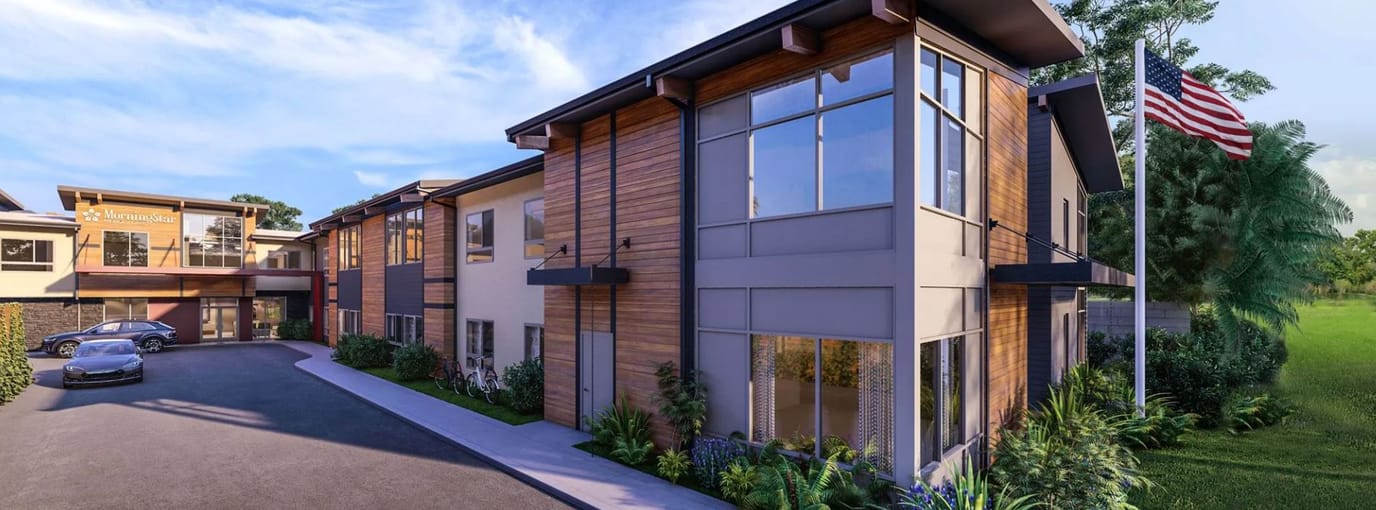 Exterior view of a senior living facility with landscaped entrance