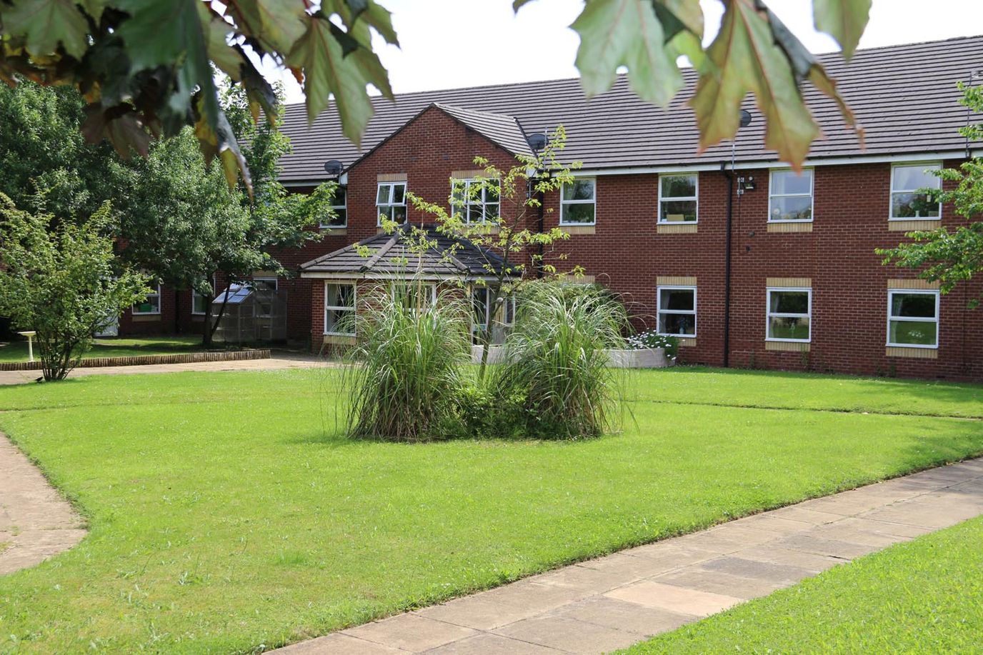 Exterior view of Millfield Care Home and garden area
