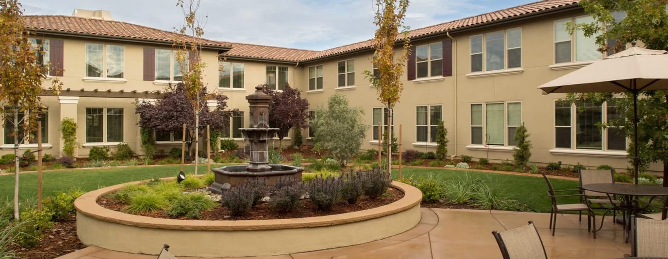 Outdoor courtyard featuring a fountain and landscaping