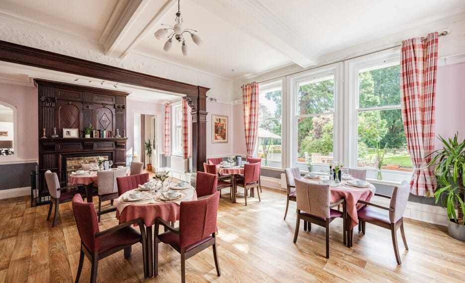 Elegant dining room with tables set for meals