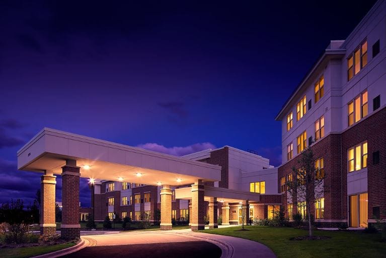 Exterior view of assisted living facility at dusk