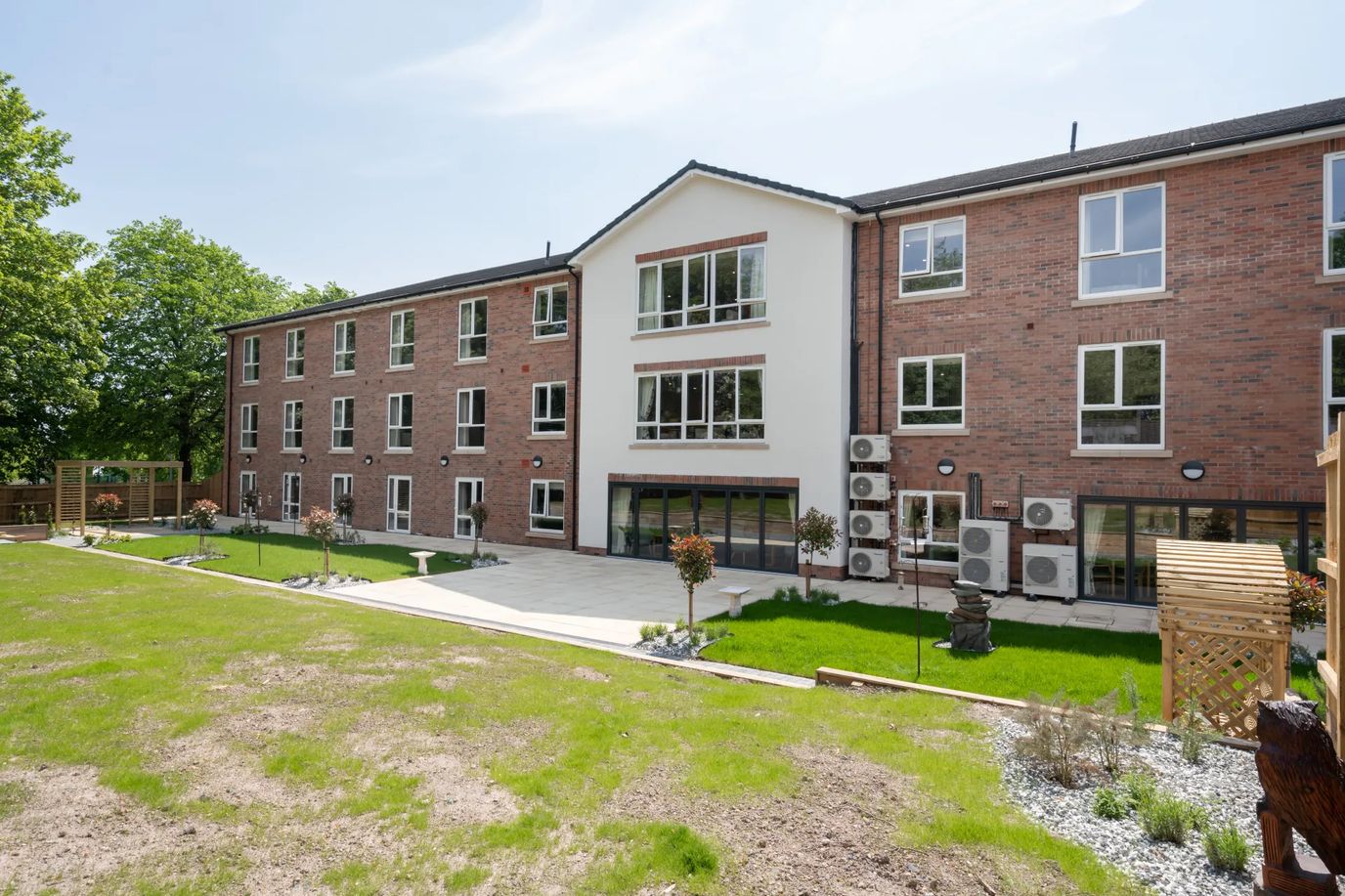 Exterior view of The Maples Care Home building and outdoor space