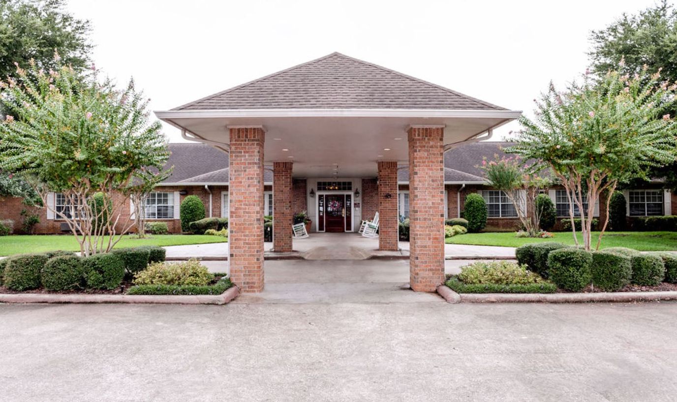 Front entrance of a senior living facility with landscaping