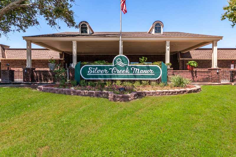 Exterior view of Silver Creek Manor with signage