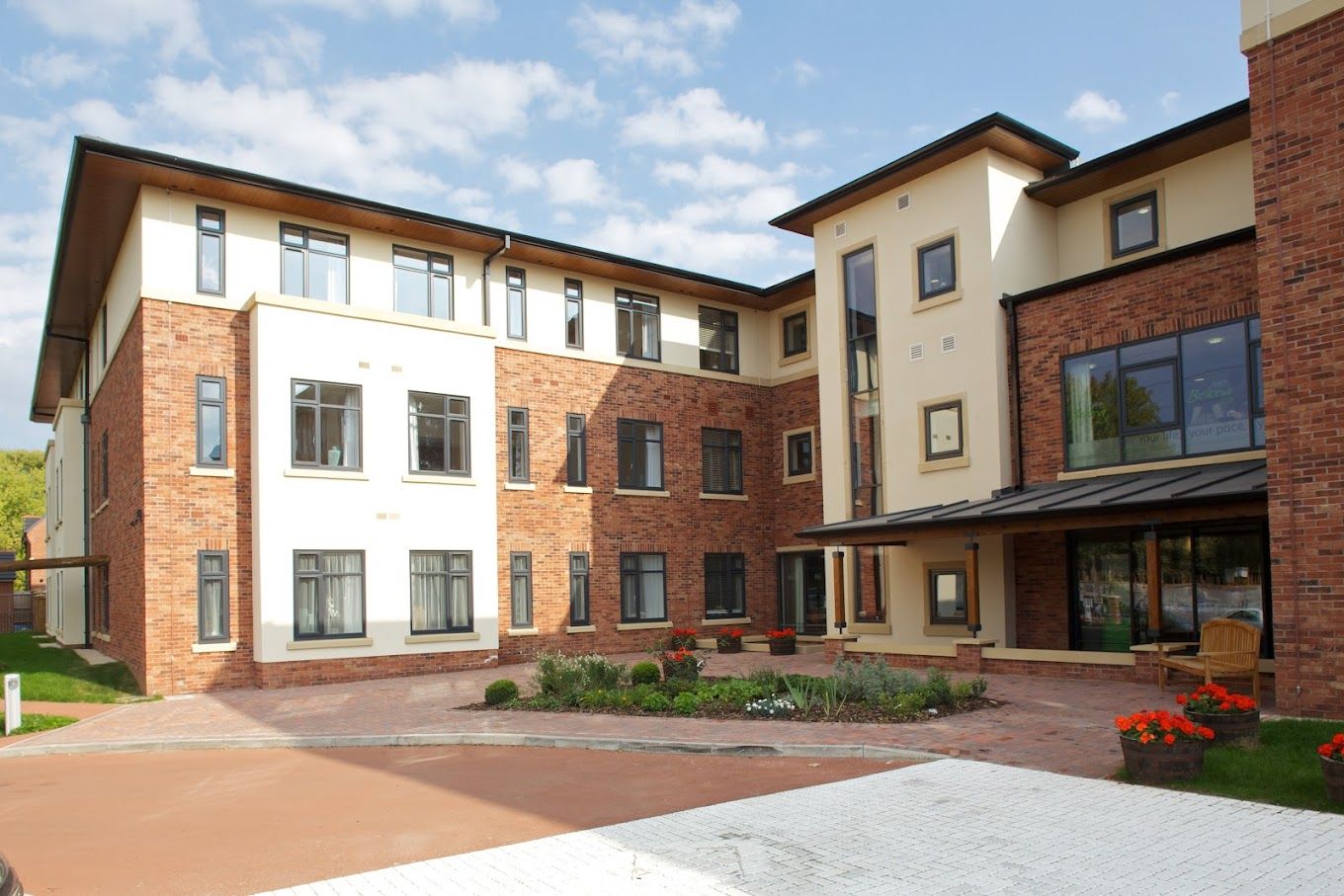 Exterior view of a senior living facility with landscaped entrance