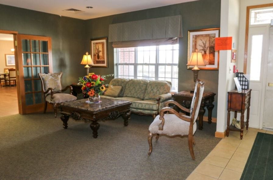 Vintage Park at Kansas, assisted living — Cozy seating area with floral decor and natural light