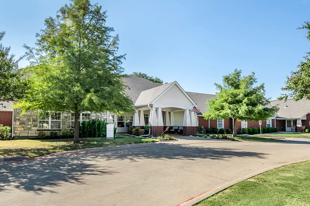 Exterior view of Brookdale Waxahachie with trees and entrance