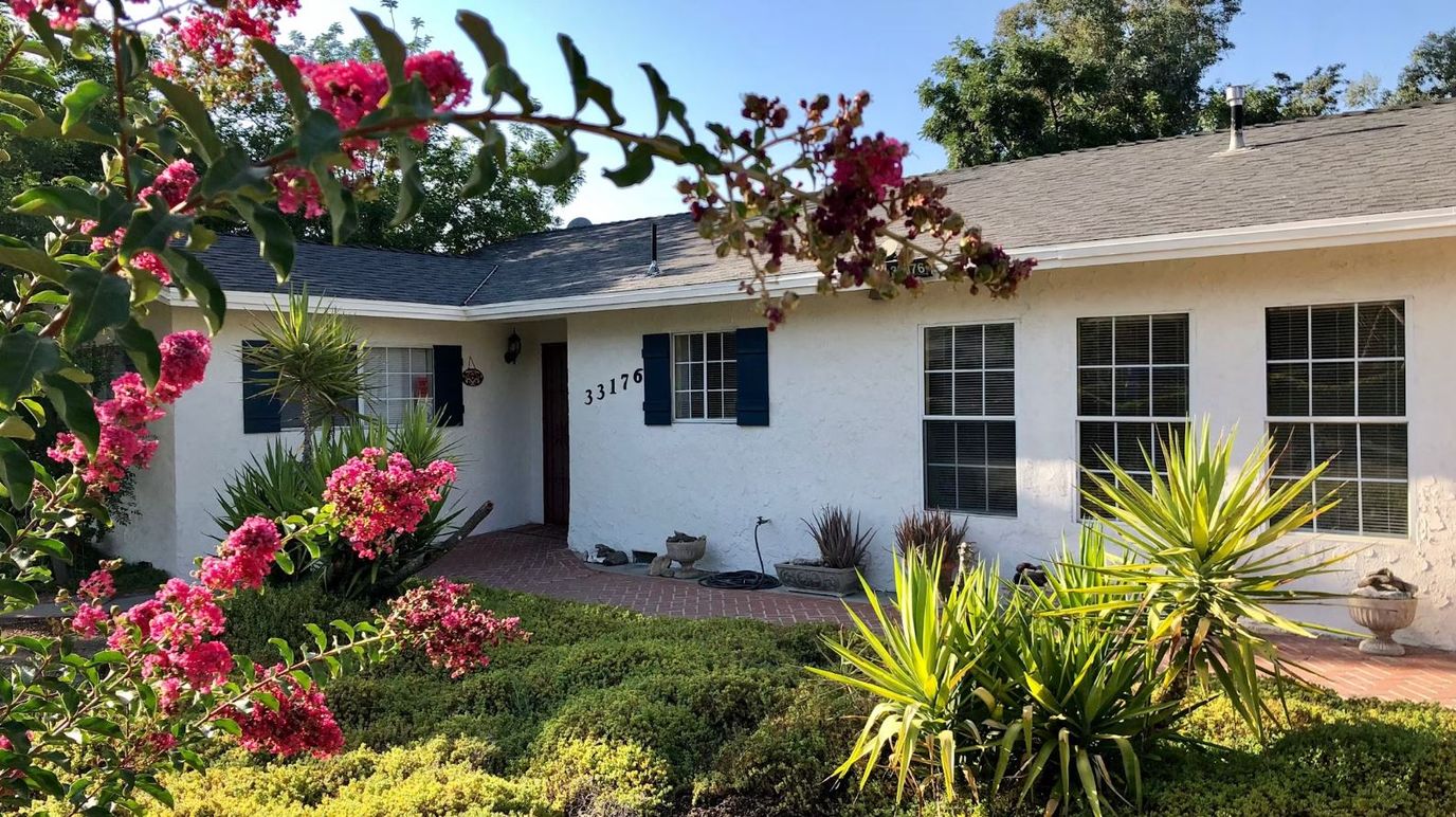 Exterior view of a senior living facility with landscaping