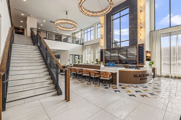 Bright and modern lobby area with seating and a staircase