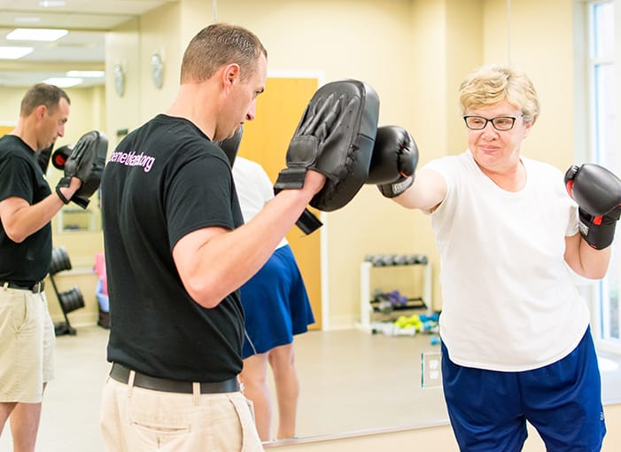 Residents engaging in boxing training during a fitness activity