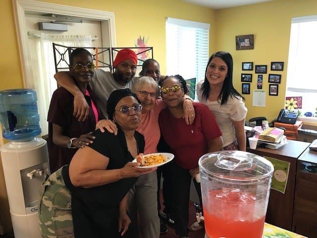 Residents and staff enjoying a group activity in a cozy room