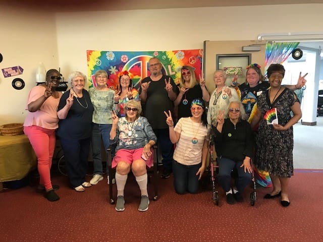 Residents celebrating with peace signs and colorful attire
