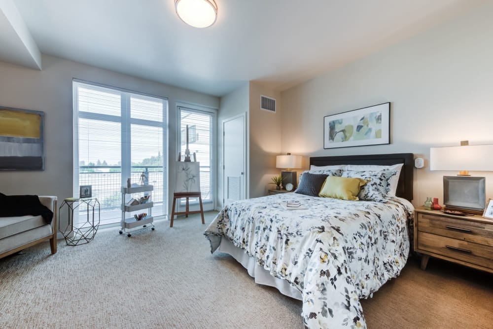 Brightly furnished resident bedroom with large windows