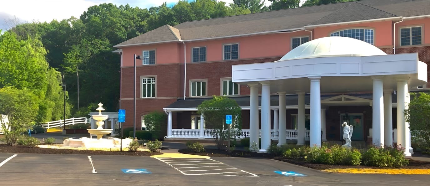 Front entrance of Grace Manor with fountain and landscaping